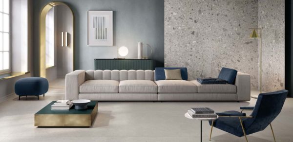 A modern sofa in a room tiled with the Silver Grain collection tile by Italgraniti