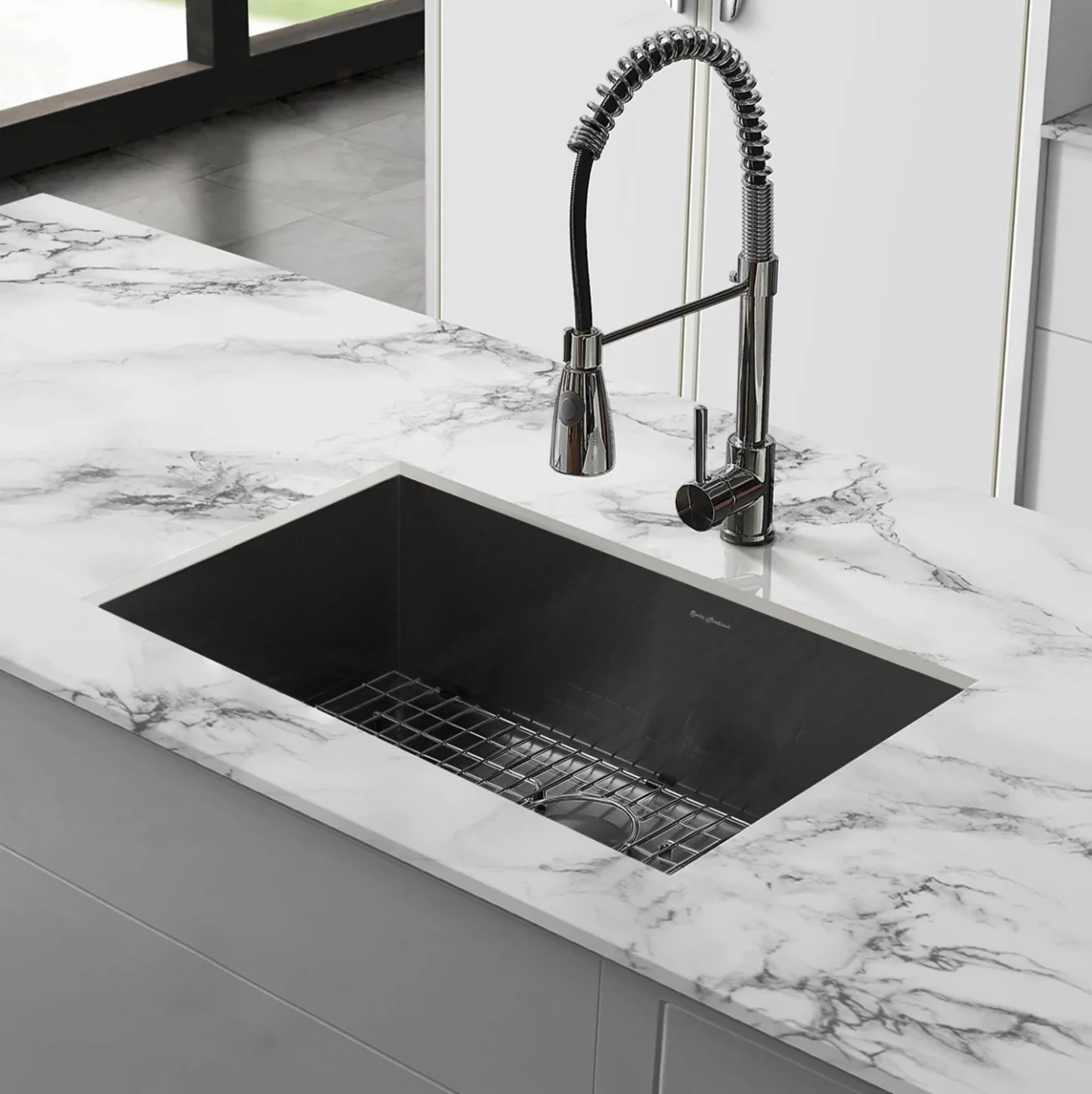 White marble look porcelain slab around a kitchen sink.